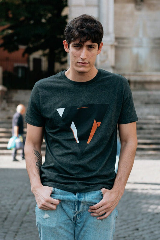 Man wearing the JUNE dark heather gret t-shirt from JCKR Clothing with the classic printed logo