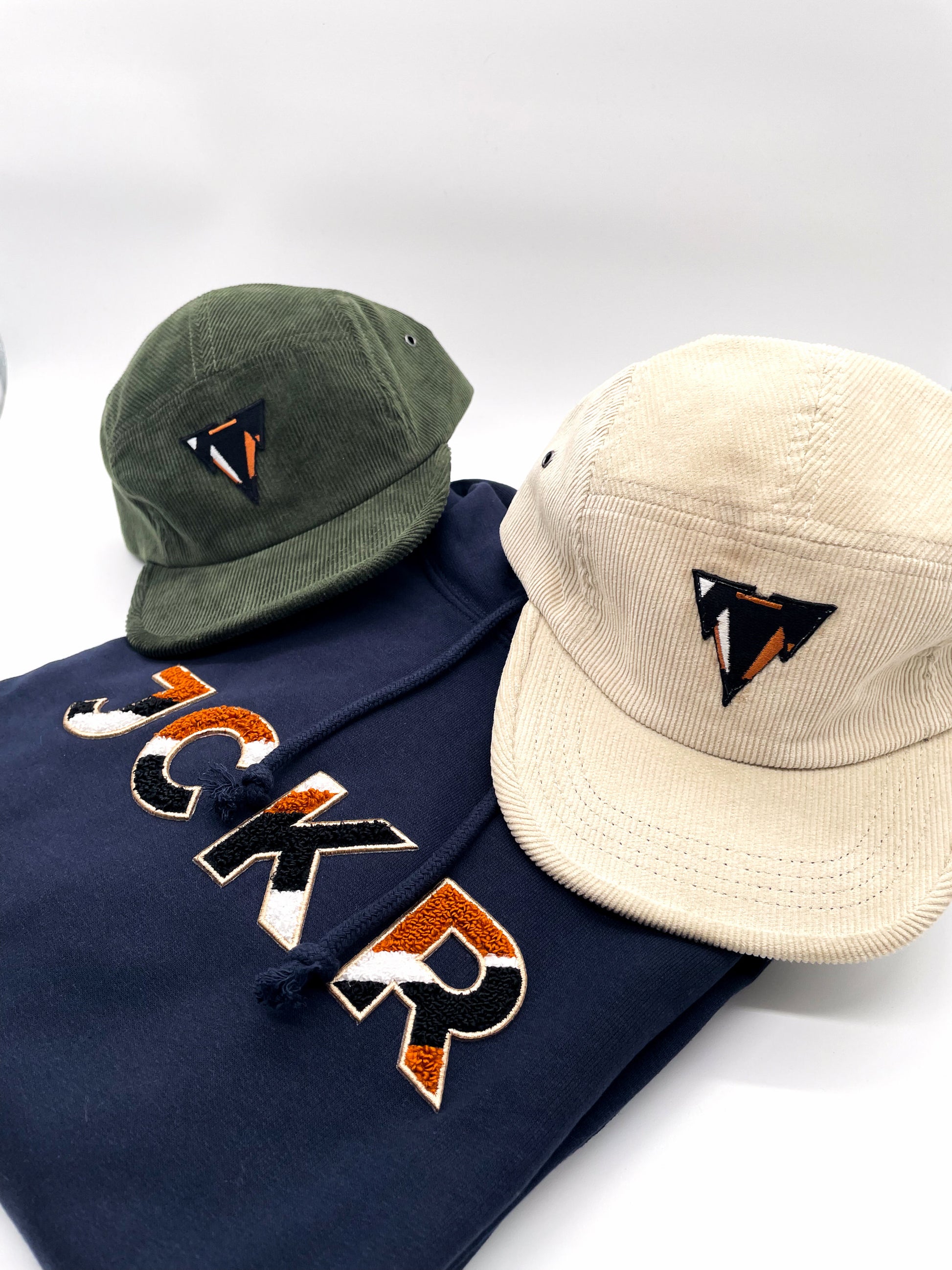 Two curdoroy winter 5panel caps with JCKR embroidered logo and a navy hoodie with JCKR chenille patch
