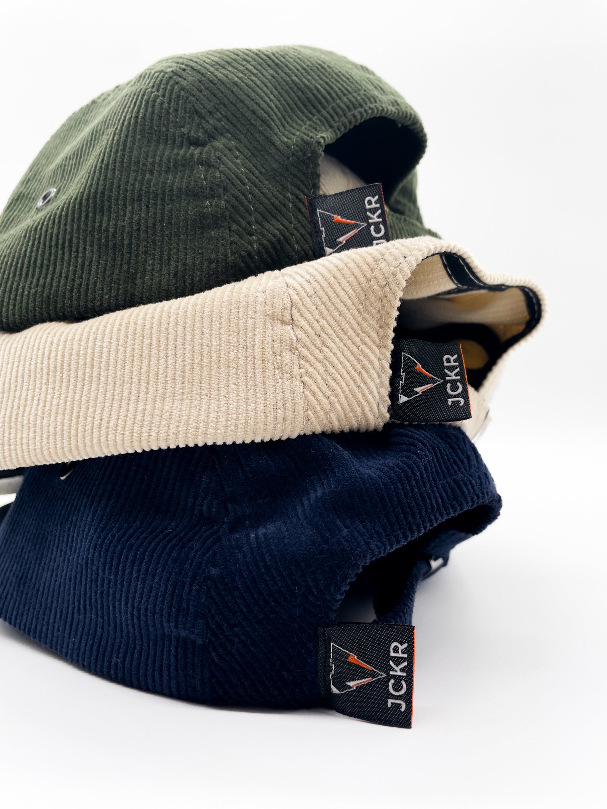 navy blue, beige and green fine corduroy 5 panels hats details with JCKR logo embroidered patch on the front and label on the back