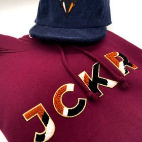 Navy blue corduroy cap and bordeaux hoodie with JCKR Chenille patch
