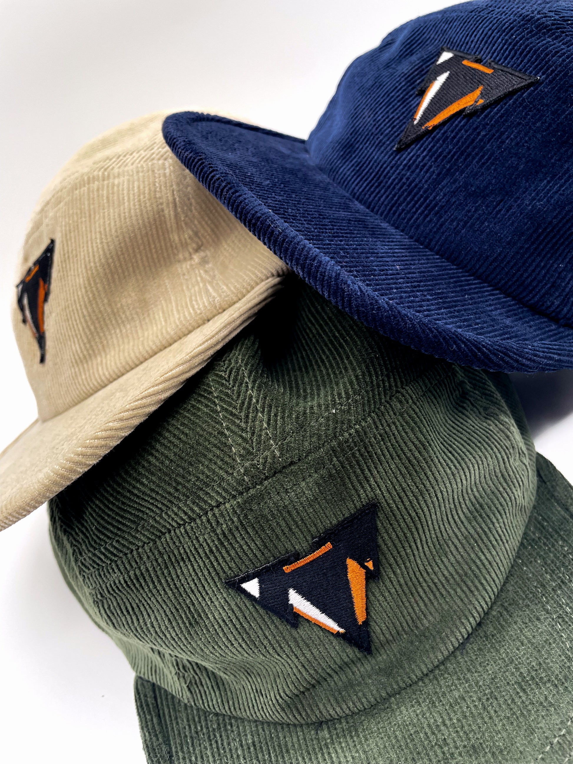 green navy and light beige fine corduroy 5 panels hats with JCKR logo embroidered patch on the front