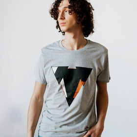 Man wearing the JUNE light heather gret t-shirt from JCKR Clothing with the classic printed logo