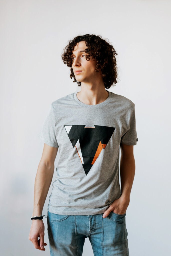 Man wearing the JUNE light heather gret t-shirt from JCKR Clothing with the classic printed logo