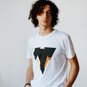 Man wearing the JUNE organic cotton in white t-shirt from JCKR Clothing with the classic printed logo