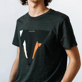 Man wearing the JUNE dark heather gret t-shirt from JCKR Clothing with the classic printed logo