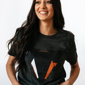 Woman wearing the JUNE dark heather gret t-shirt from JCKR Clothing with the classic printed logo