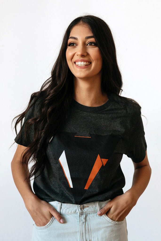 Woman wearing the JUNE dark heather gret t-shirt from JCKR Clothing with the classic printed logo