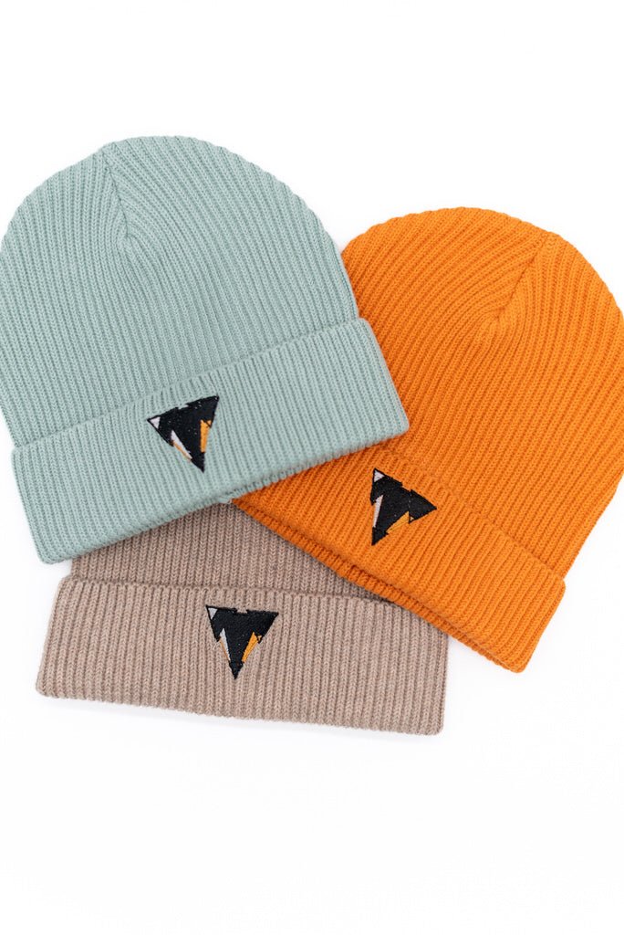 Three PEREC beanies in aloe, orange, and beige with the embroidered JCKR logo on a white background