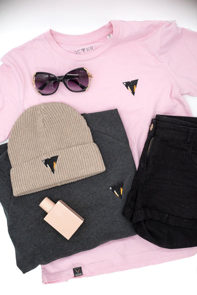 Pink JAM t-shirt with black shorts, beige beanie, sunglasses, and RUSSELL sweater in heather grey from JCKR clothing